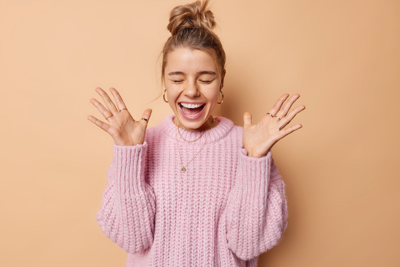 Happy woman holding her hands up in excitement